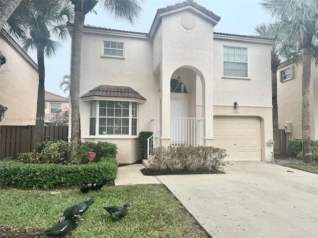 10781 NW 12th Dr, Plantation, FL 33322 - view of front of home with stucco siding, an attached garage, a tiled roof, and concrete driveway