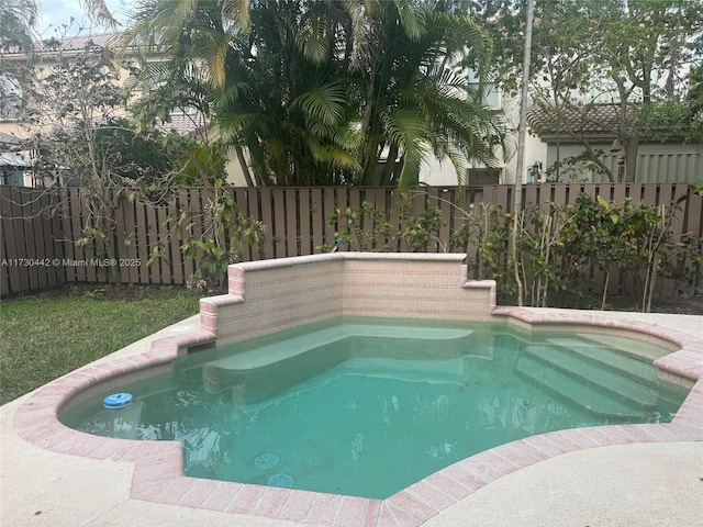 view of swimming pool featuring a fenced backyard