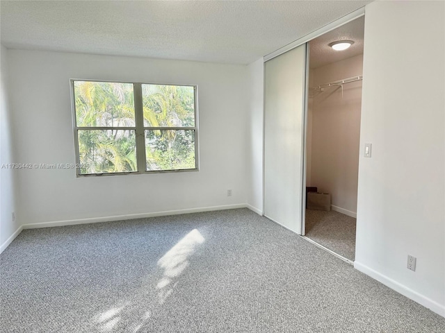 10781 NW 12th Dr, Plantation, FL 33322 - unfurnished bedroom with a textured ceiling, carpet flooring, and a closet