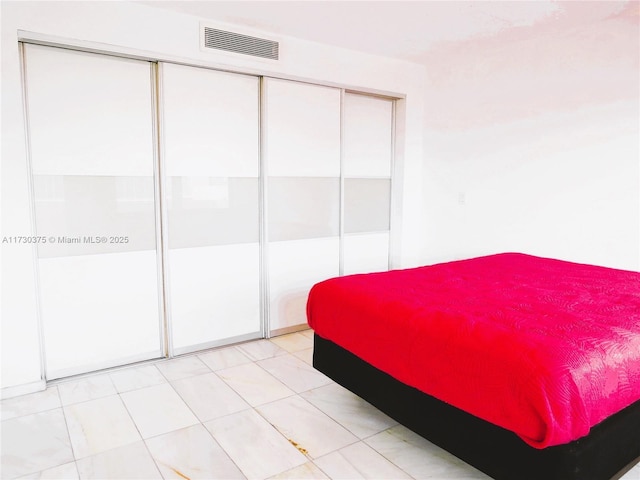 tiled bedroom with a closet