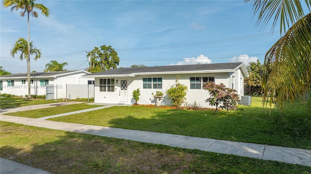 single story home featuring a front lawn