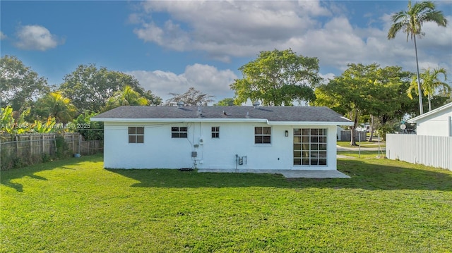 rear view of house with a yard