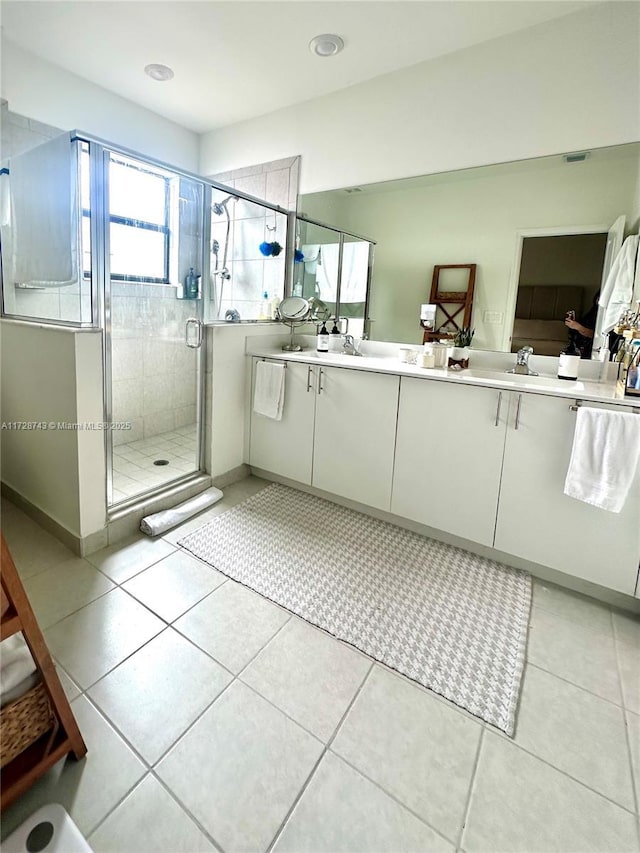 bathroom featuring an enclosed shower, tile patterned floors, and vanity