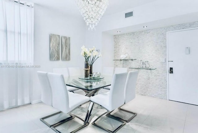 tiled dining area with a notable chandelier