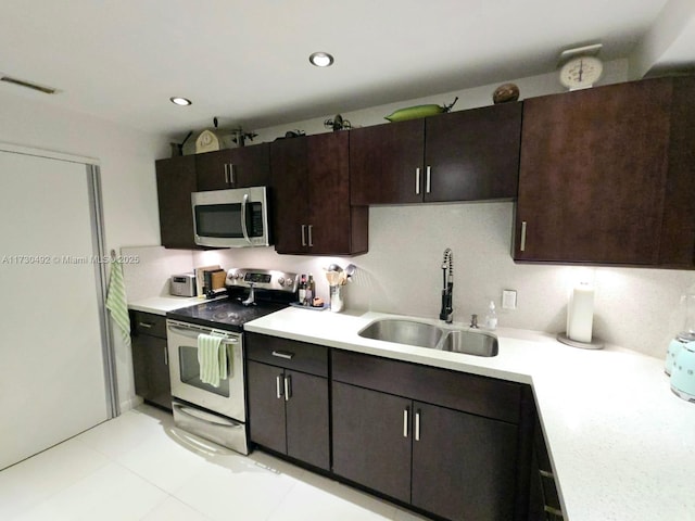 kitchen with sink, dark brown cabinets, and appliances with stainless steel finishes