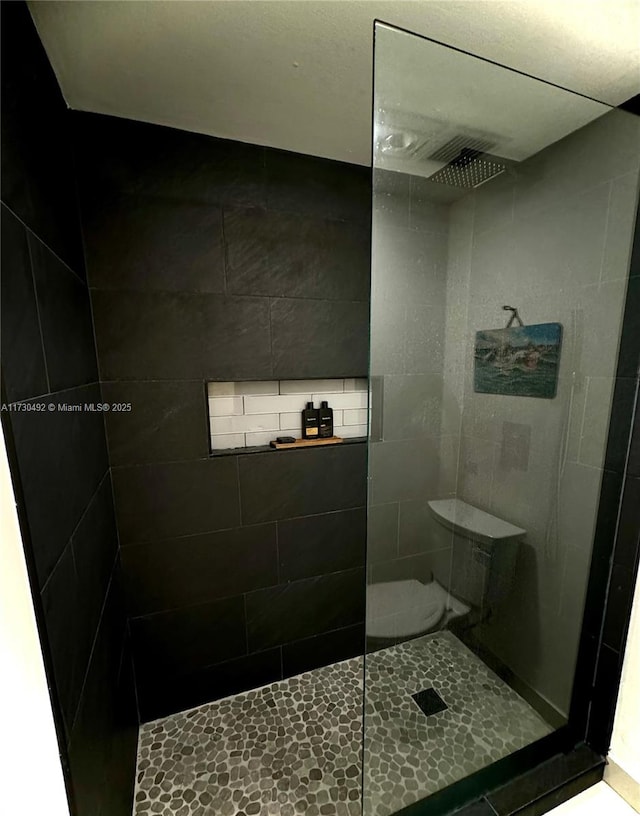 bathroom with tiled shower