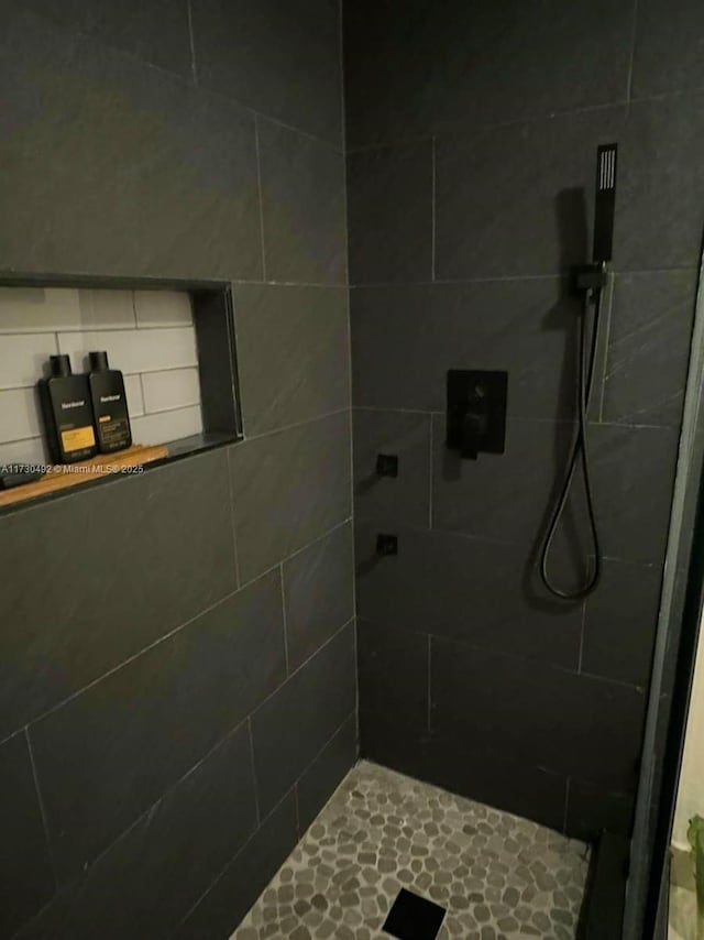 bathroom with a tile shower