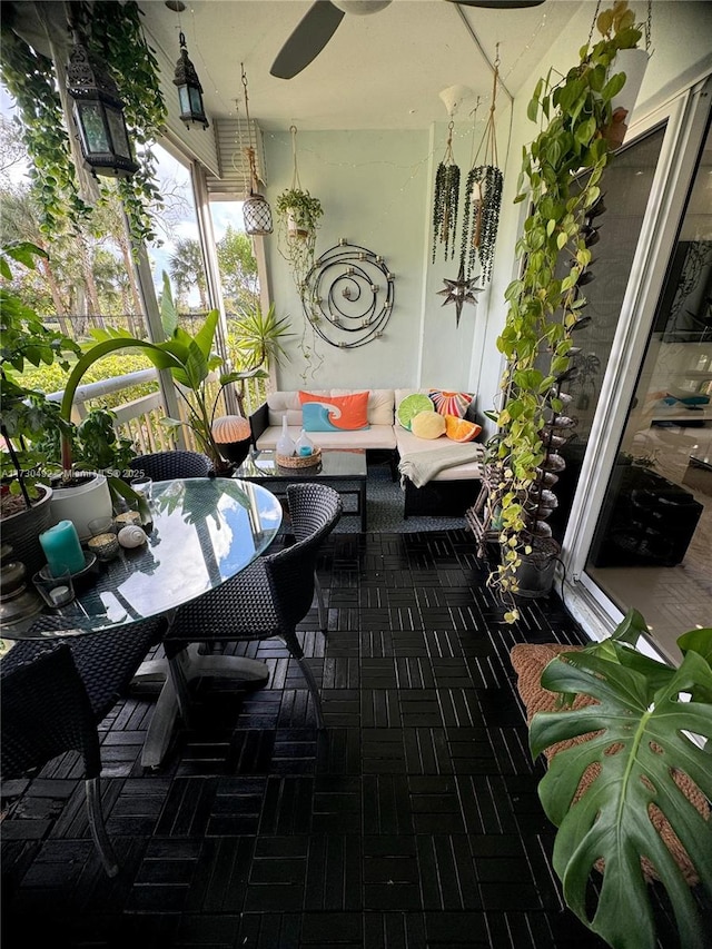 sunroom featuring ceiling fan