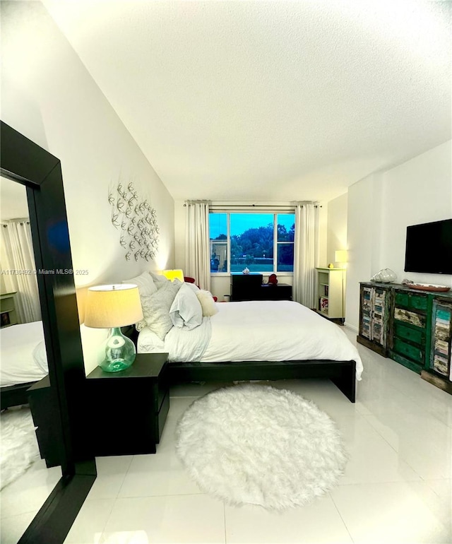 tiled bedroom with a textured ceiling