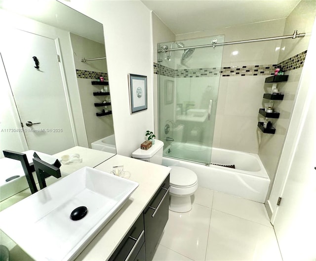 full bathroom with tile patterned flooring, bath / shower combo with glass door, vanity, and toilet