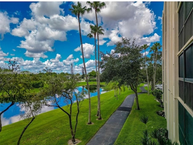 view of home's community with a yard and a water view