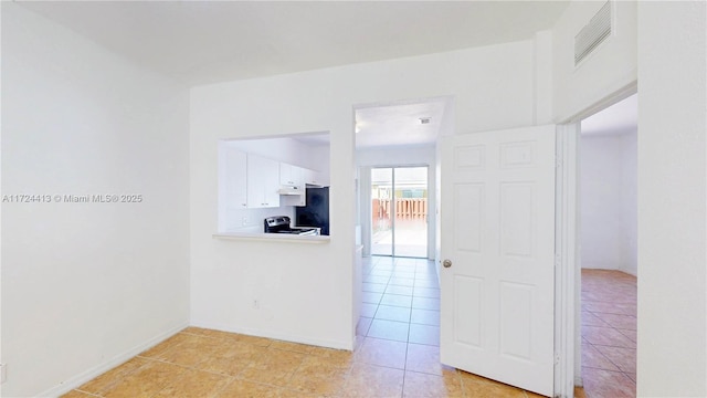 empty room featuring light tile patterned floors and visible vents