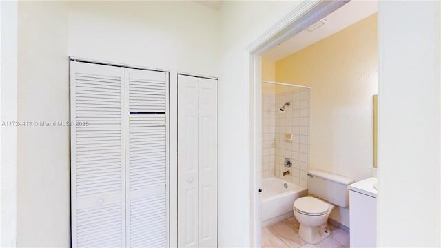 bathroom with a closet, tile patterned floors, toilet, and shower / bath combination