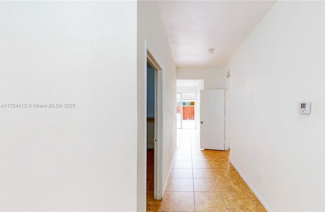 hall featuring light tile patterned floors