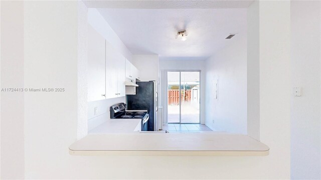 full bathroom with tiled shower / bath combo, toilet, tile patterned flooring, and vanity