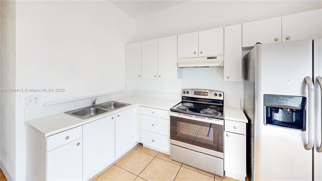 kitchen with light tile patterned floors, white cabinetry, and appliances with stainless steel finishes