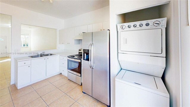 kitchen with white cabinets, stainless steel appliances, and light tile patterned flooring