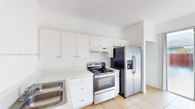 kitchen featuring light tile patterned floors, white cabinets, appliances with stainless steel finishes, and sink