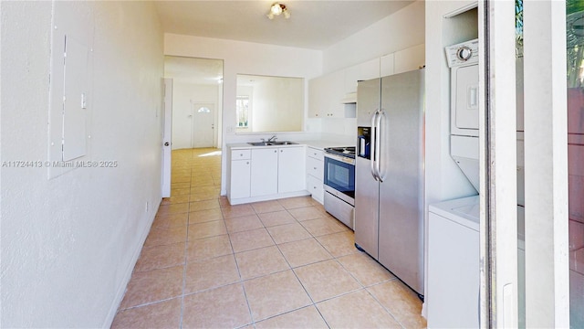 kitchen featuring light tile patterned floors, stainless steel fridge with ice dispenser, a sink, white cabinets, and electric stove