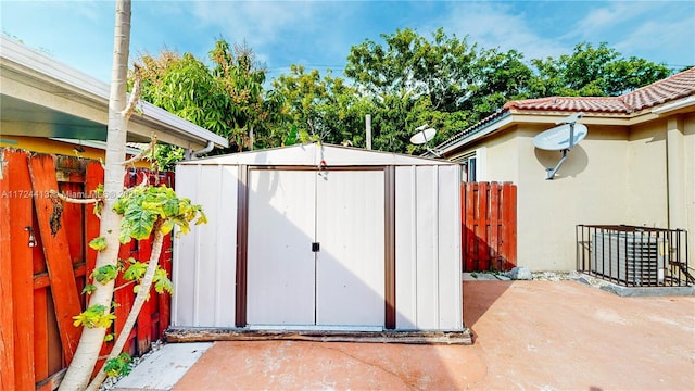 view of shed with fence