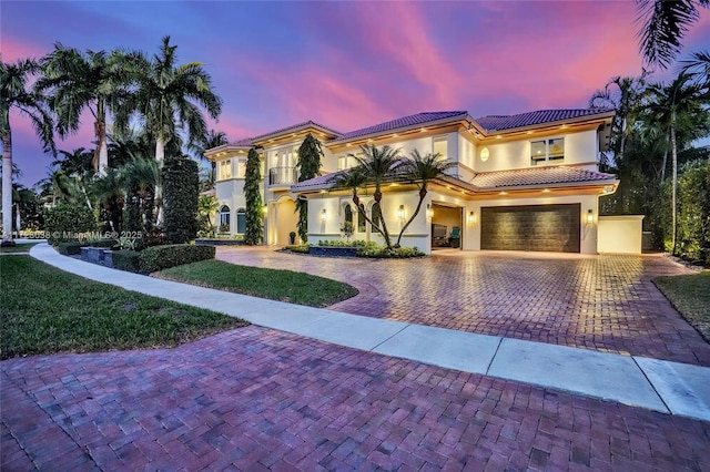 mediterranean / spanish-style home with a garage