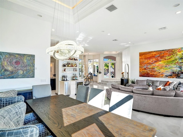 interior space featuring bar and an inviting chandelier