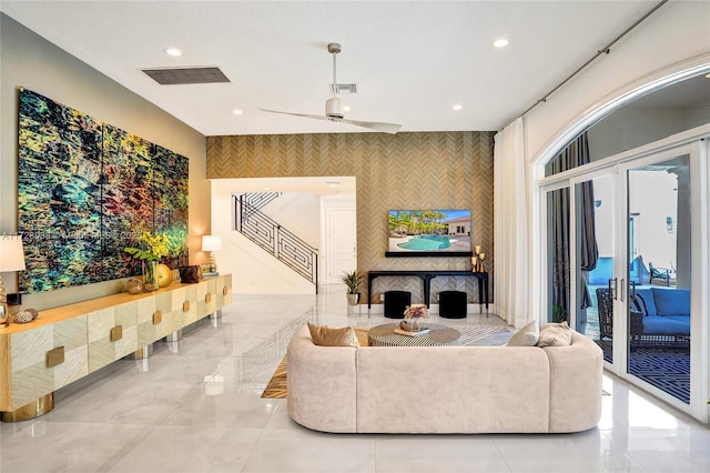 living room featuring ceiling fan and french doors