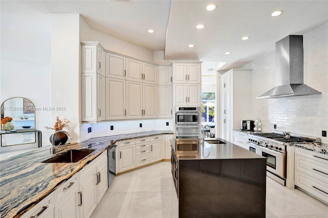 kitchen featuring backsplash, wall chimney range hood, white cabinets, and stainless steel appliances