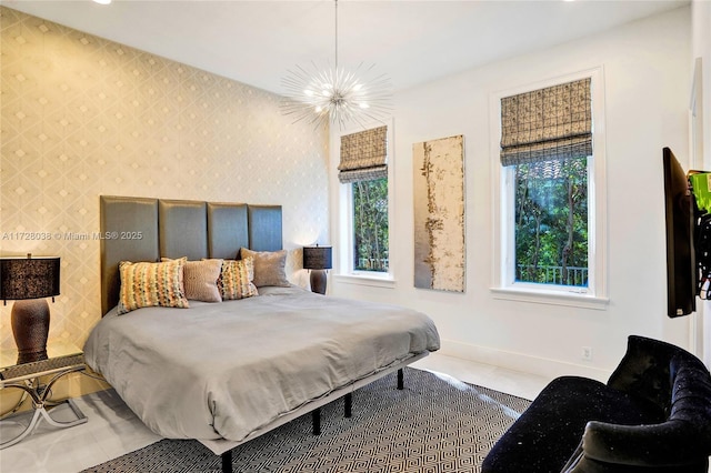 bedroom with tile patterned floors and a chandelier