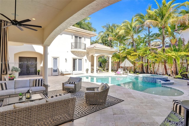 view of pool featuring ceiling fan, french doors, an in ground hot tub, outdoor lounge area, and a patio area