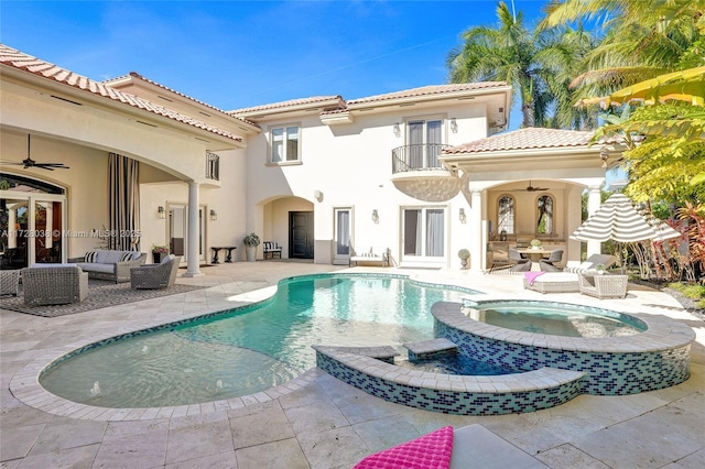 rear view of property with ceiling fan, a patio area, a pool with hot tub, and an outdoor living space