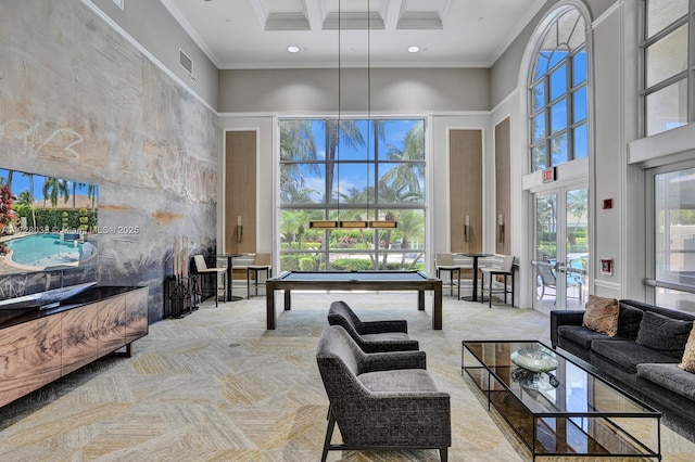 carpeted living room with french doors, billiards, crown molding, and a towering ceiling