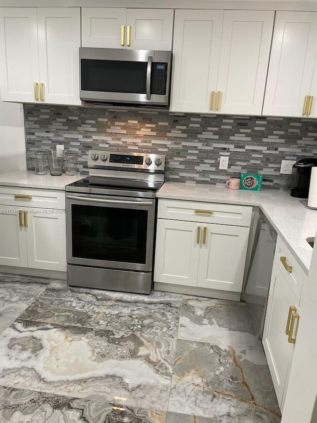 kitchen featuring white cabinetry, backsplash, and appliances with stainless steel finishes