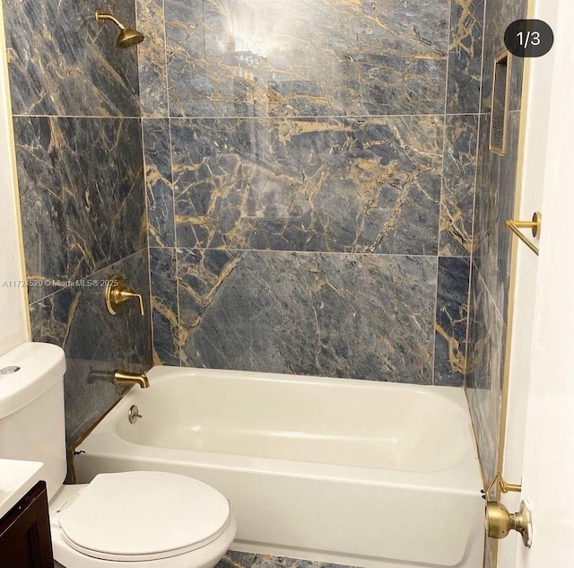 full bathroom featuring toilet, vanity, and shower / washtub combination