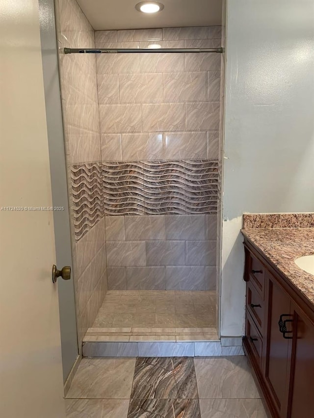 bathroom with a shower and vanity