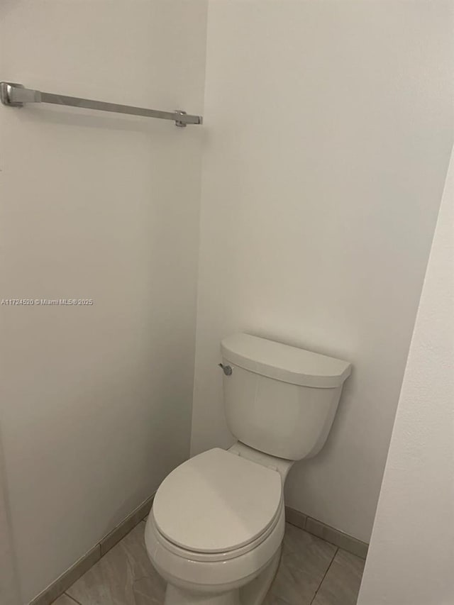 bathroom featuring toilet and tile patterned floors