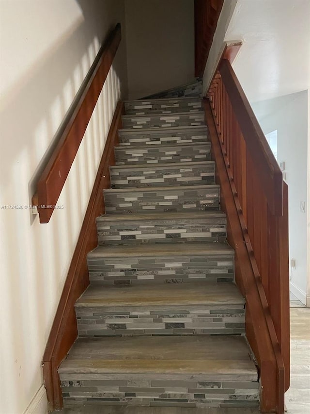 stairway featuring hardwood / wood-style flooring