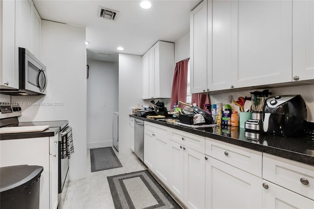 kitchen with sink, white cabinets, and stainless steel appliances