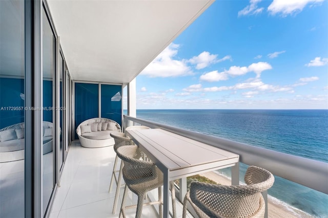 balcony with a water view and a beach view