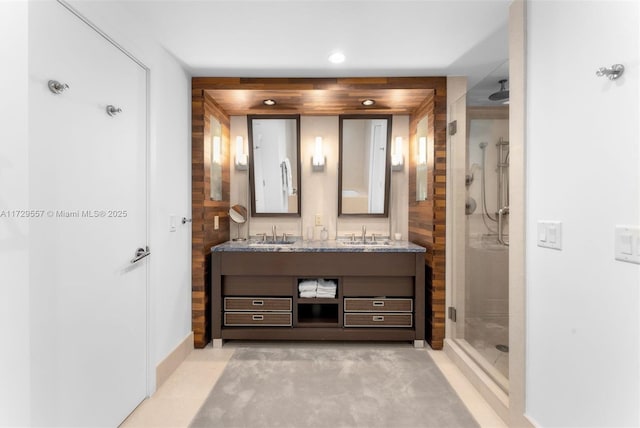 bathroom featuring vanity and a shower with shower door