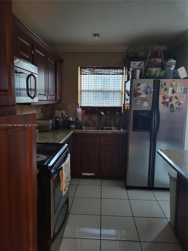 kitchen featuring stainless steel appliances, sink, ornamental molding, light tile patterned flooring, and dark brown cabinets