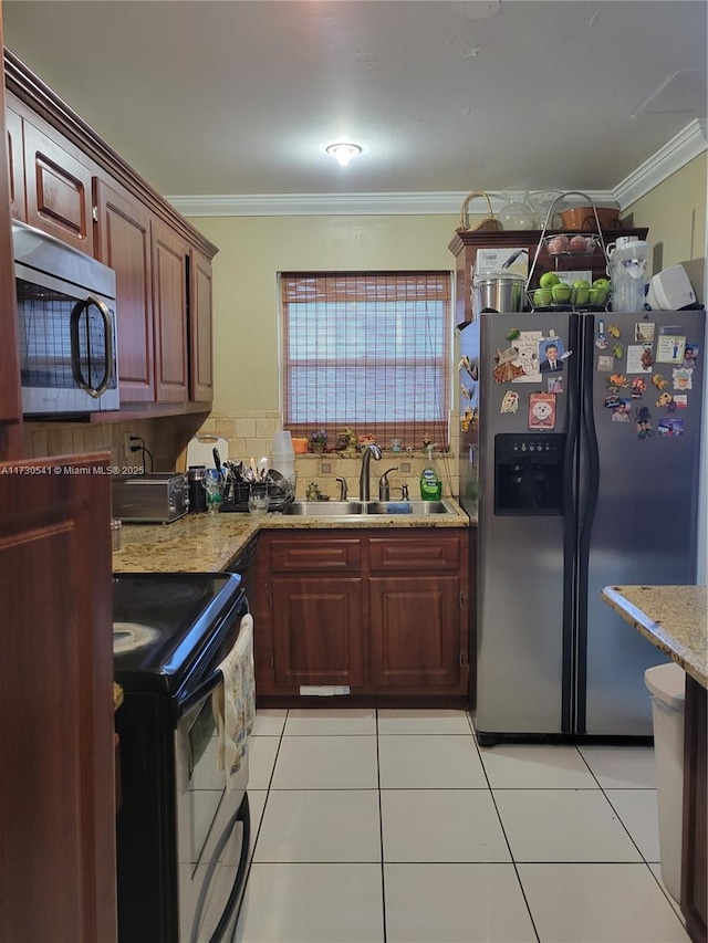 kitchen with crown molding, light stone countertops, light tile patterned floors, sink, and stainless steel appliances