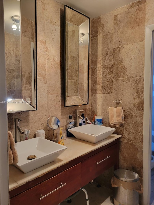 bathroom featuring tile walls and vanity