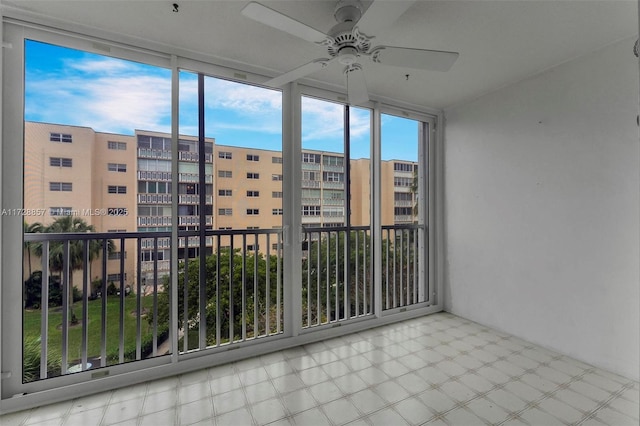 unfurnished sunroom featuring ceiling fan