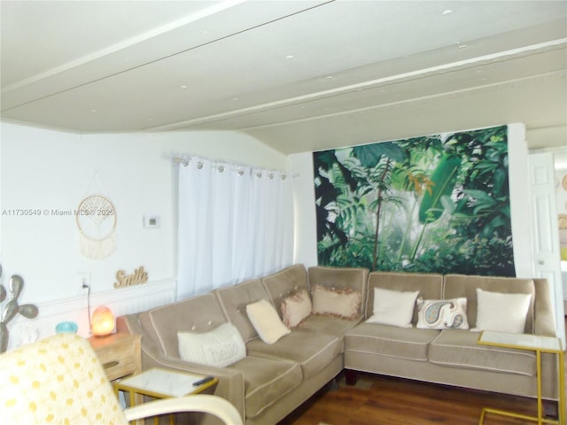 living room with beam ceiling and dark hardwood / wood-style flooring