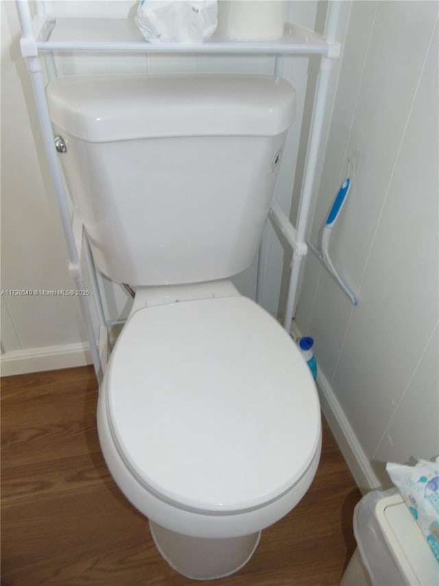 bathroom with hardwood / wood-style floors and toilet