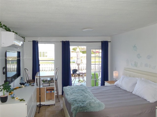 tiled bedroom featuring a wall mounted AC and access to outside