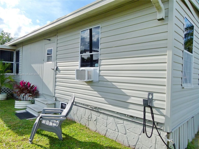 view of home's exterior with a yard and cooling unit