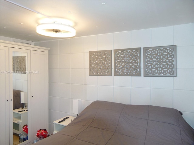 unfurnished bedroom featuring tile walls