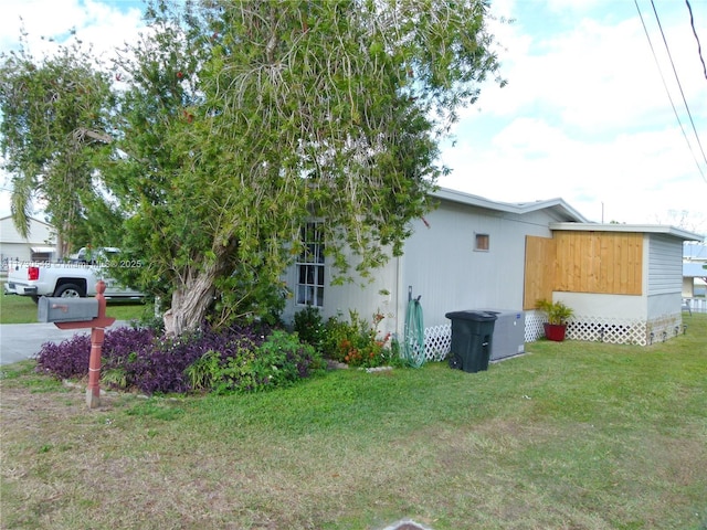 view of property exterior with a lawn